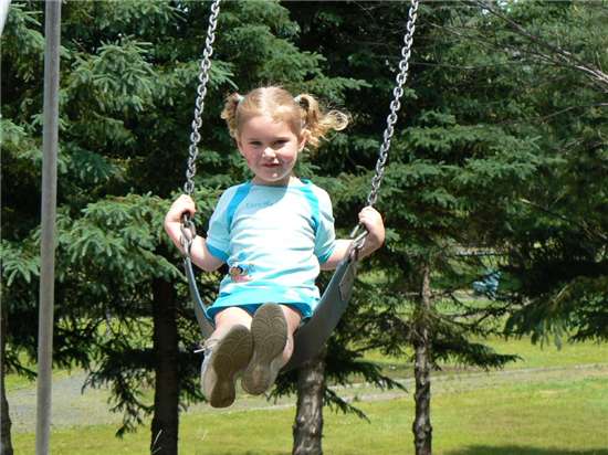 Amy Walls on the swing in the playground at Blackville Park