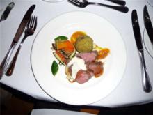 Roasted tenderloin of beef with goat cheese foam, braised lamb crouquette and winter squash rissotto.
