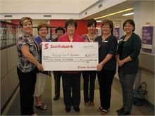 Valerie Comeau and her Scotiabank staff presenting a cheque for $1200 to Barbara Stothart, president of the Rotary Club of Newcastle.  Scotiabank employees sold 1/2 and 1/2 tickets at Rotary Springfest and raised $600.  With Scotiabank's Team Community Matching Program they were able to double that and donate $1200 to the Rotary Club.